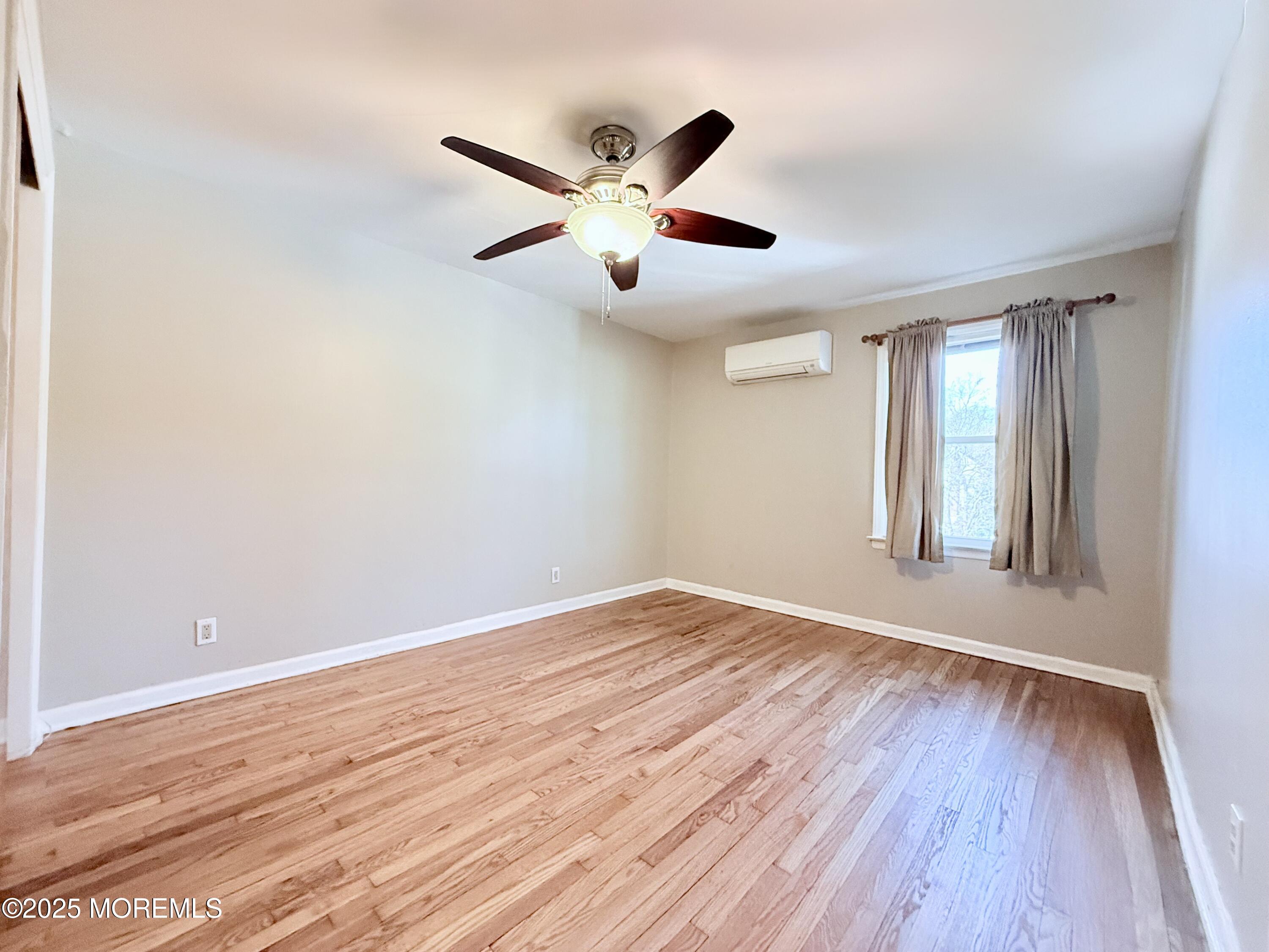 48 Broughton Avenue Bloomfield, NJ 07003 - Photo 17 of 27 a view of an empty room with wooden floor and a window