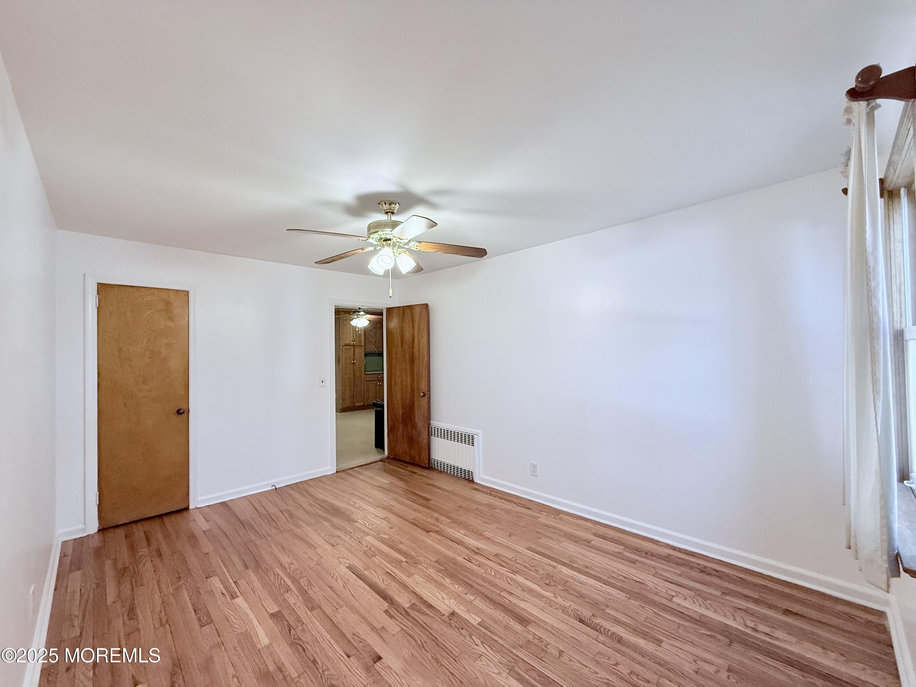 48 Broughton Avenue Bloomfield, NJ 07003 - Photo 6 of 27 a view of an empty room with wooden floor