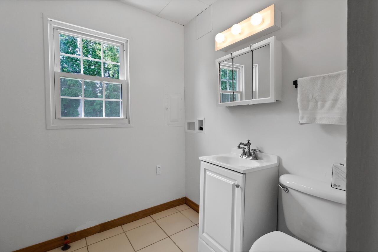 750 Fremont Road Valparaiso, IN 46385 - Photo 21 of 25 a bathroom with a sink mirror toilet and next to a window
