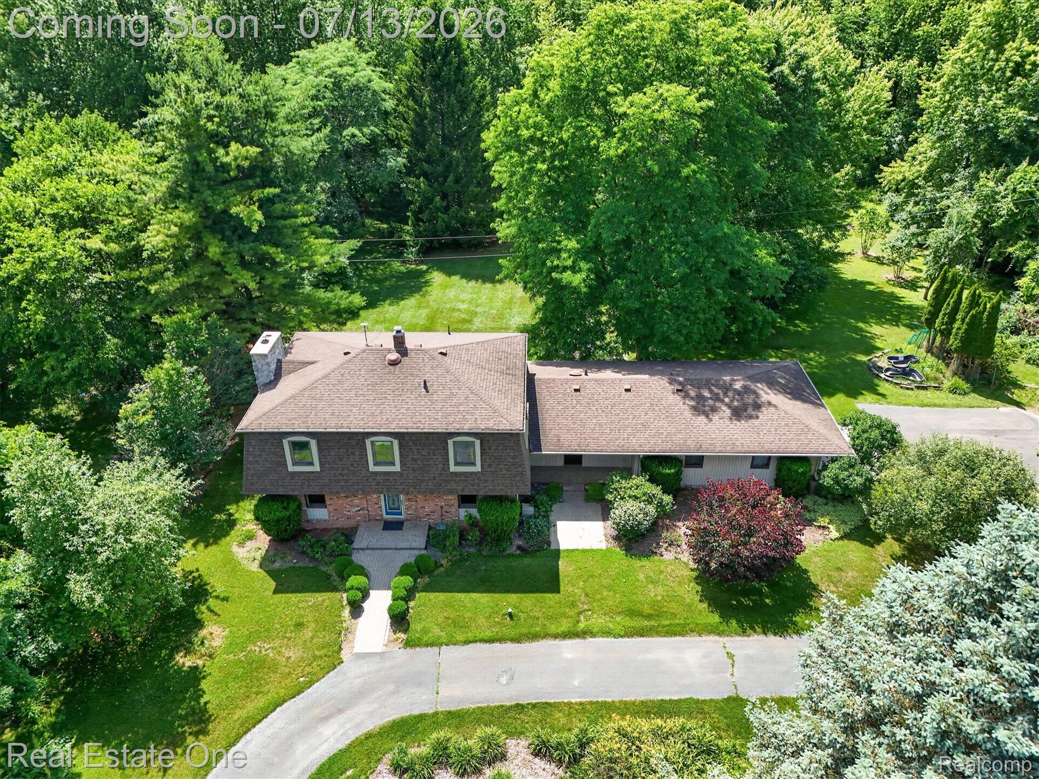 6039 Fish Lake Road Holly, MI 48442 - Photo 53 of 70 Expansive property featuring a multi-level residence with a shingle roof and brick facade accents