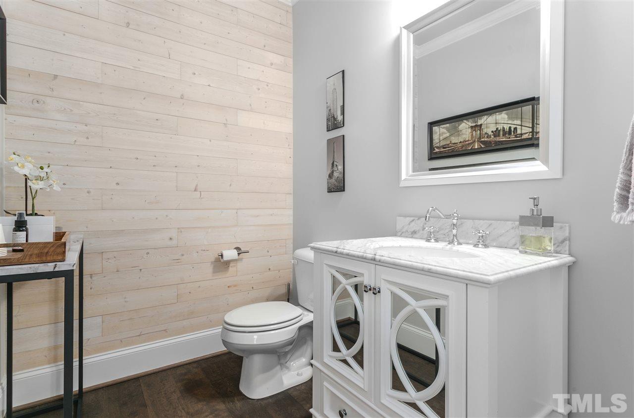 12 Hill Street Raleigh, NC 27610 - Photo 13 of 30 a bathroom with a toilet a sink and mirror