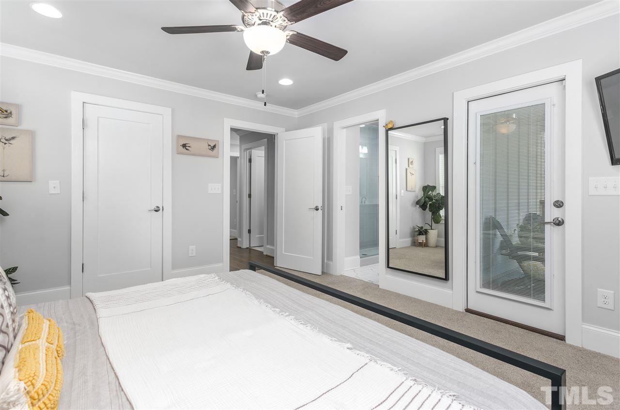12 Hill Street Raleigh, NC 27610 - Photo 16 of 30 a spacious bedroom with a large bed and a chandelier