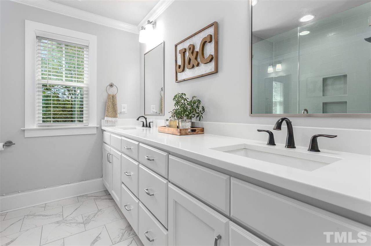 12 Hill Street Raleigh, NC 27610 - Photo 18 of 30 a bathroom with double sink and a mirror