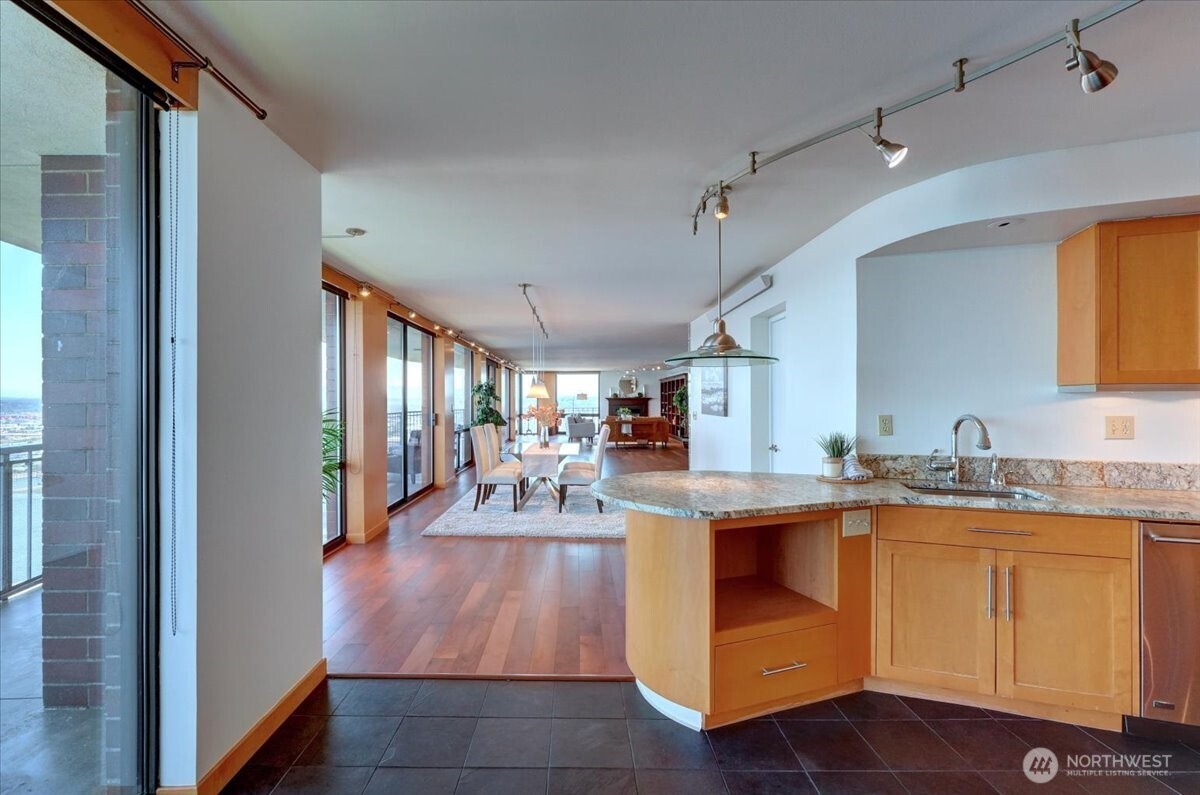 1 North Stadium Way, Unit 16 Tacoma, WA 98403 - Photo 13 of 39 a view of a kitchen with kitchen island a sink wooden floor and living room view
