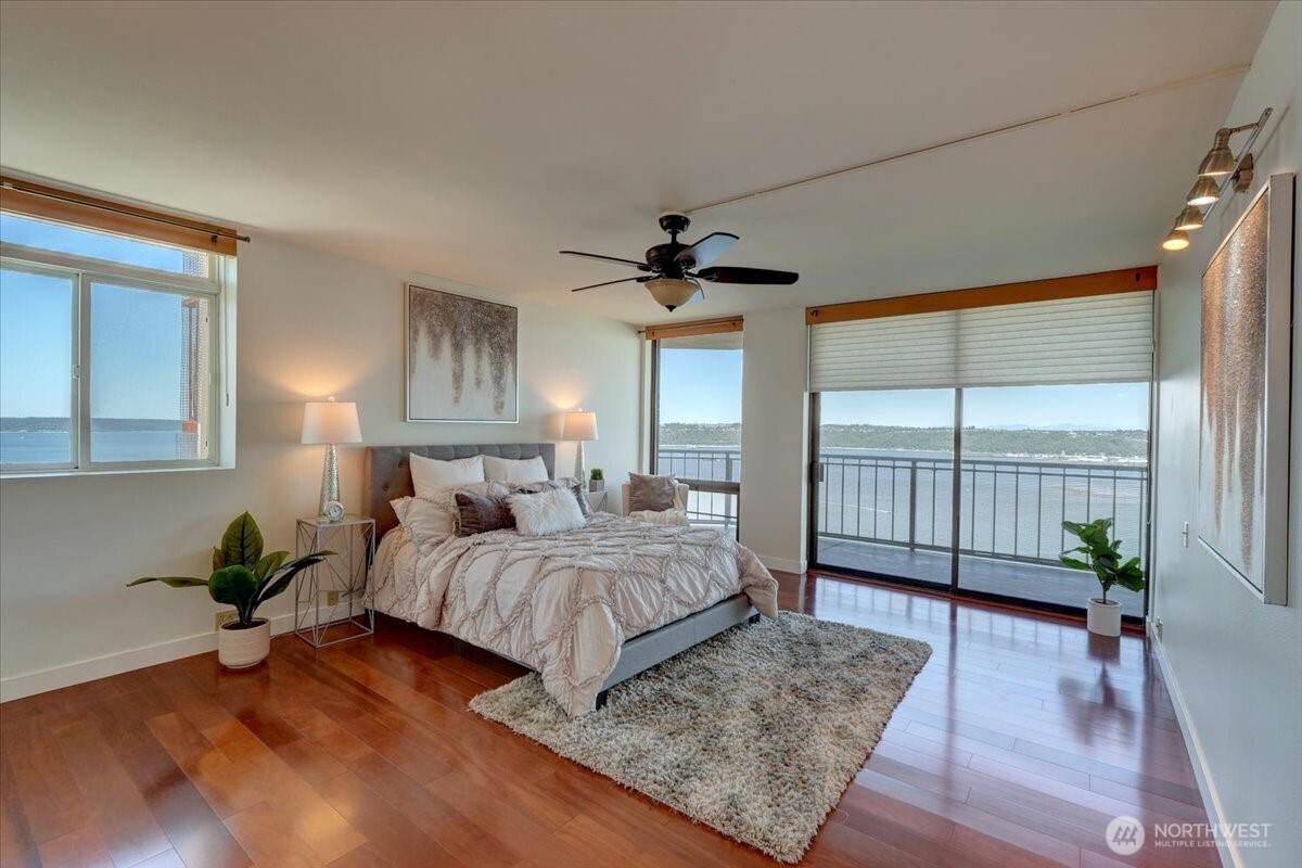 1 North Stadium Way, Unit 16 Tacoma, WA 98403 - Photo 20 of 39 a bedroom with a large bed and wooden floor