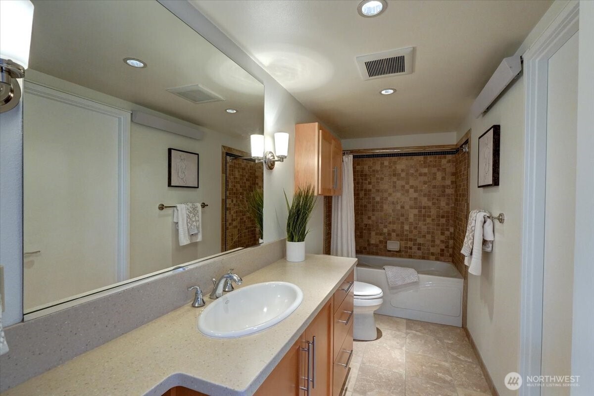 1 North Stadium Way, Unit 16 Tacoma, WA 98403 - Photo 20 of 39 a bathroom with a sink a toilet a mirror and shower