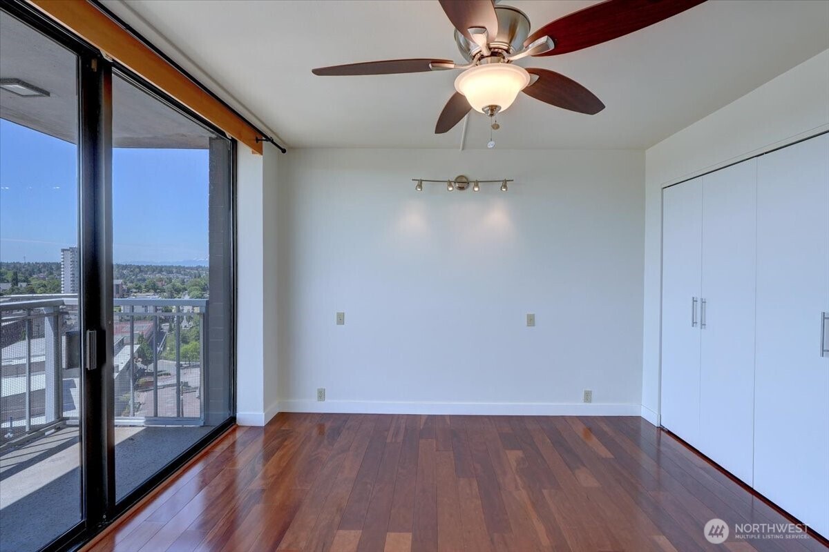 1 North Stadium Way, Unit 16 Tacoma, WA 98403 - Photo 27 of 39 an empty room with wooden floor fan and windows