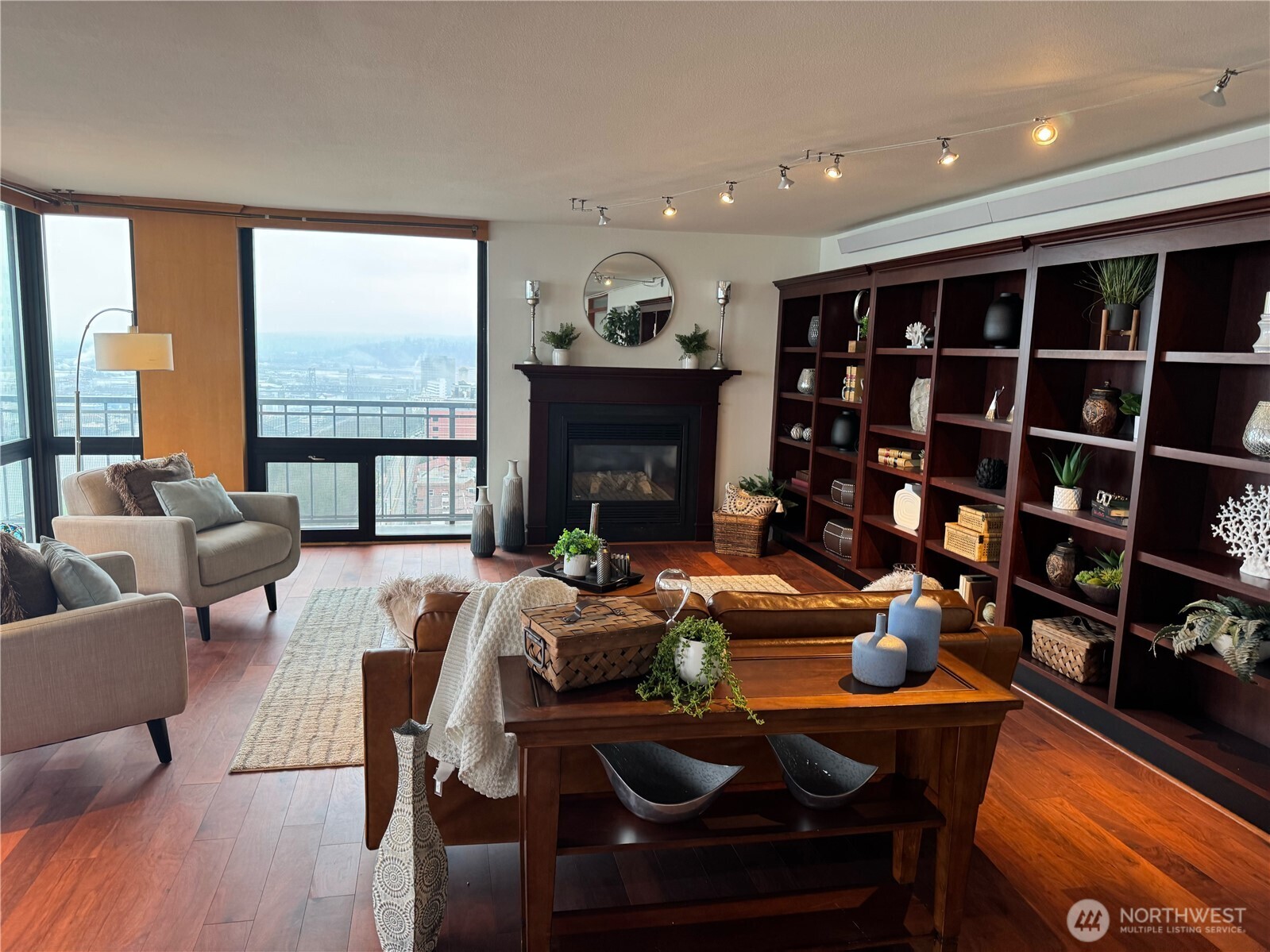 1 North Stadium Way, Unit 16 Tacoma, WA 98403 - Photo 7 of 39 a living room with furniture a fireplace and a floor to ceiling window