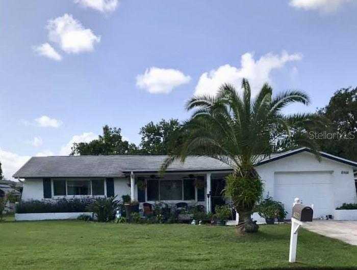 7906 Cherrytree Lane New Port Richey, FL 34653 - Photo 1 of 1 a front view of a house with garden and plants