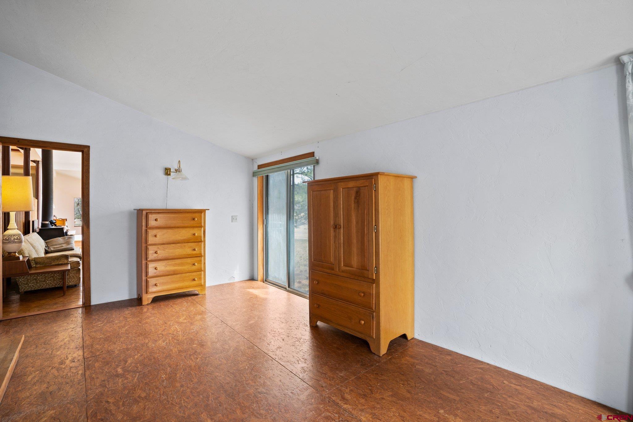 1129 Meadow Road Durango, CO 81303 - Photo 30 of 42 a view of an empty room and window with wooden floor