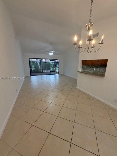 21601 Coronado Avenue Boca Raton, FL 33433 - Photo 4 of 10 a view of a room with lots of counter space and a chandelier