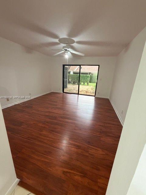 21601 Coronado Avenue Boca Raton, FL 33433 - Photo 6 of 10 an empty room with wooden floor and windows