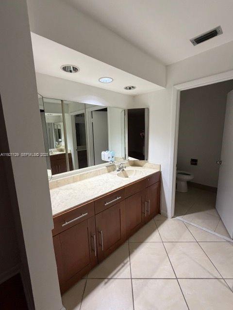 21601 Coronado Avenue Boca Raton, FL 33433 - Photo 7 of 10 a spacious bathroom with a mirror sink and vanity