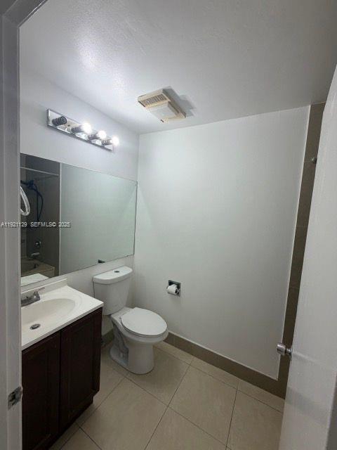 21601 Coronado Avenue Boca Raton, FL 33433 - Photo 9 of 10 a bathroom with a toilet sink and mirror