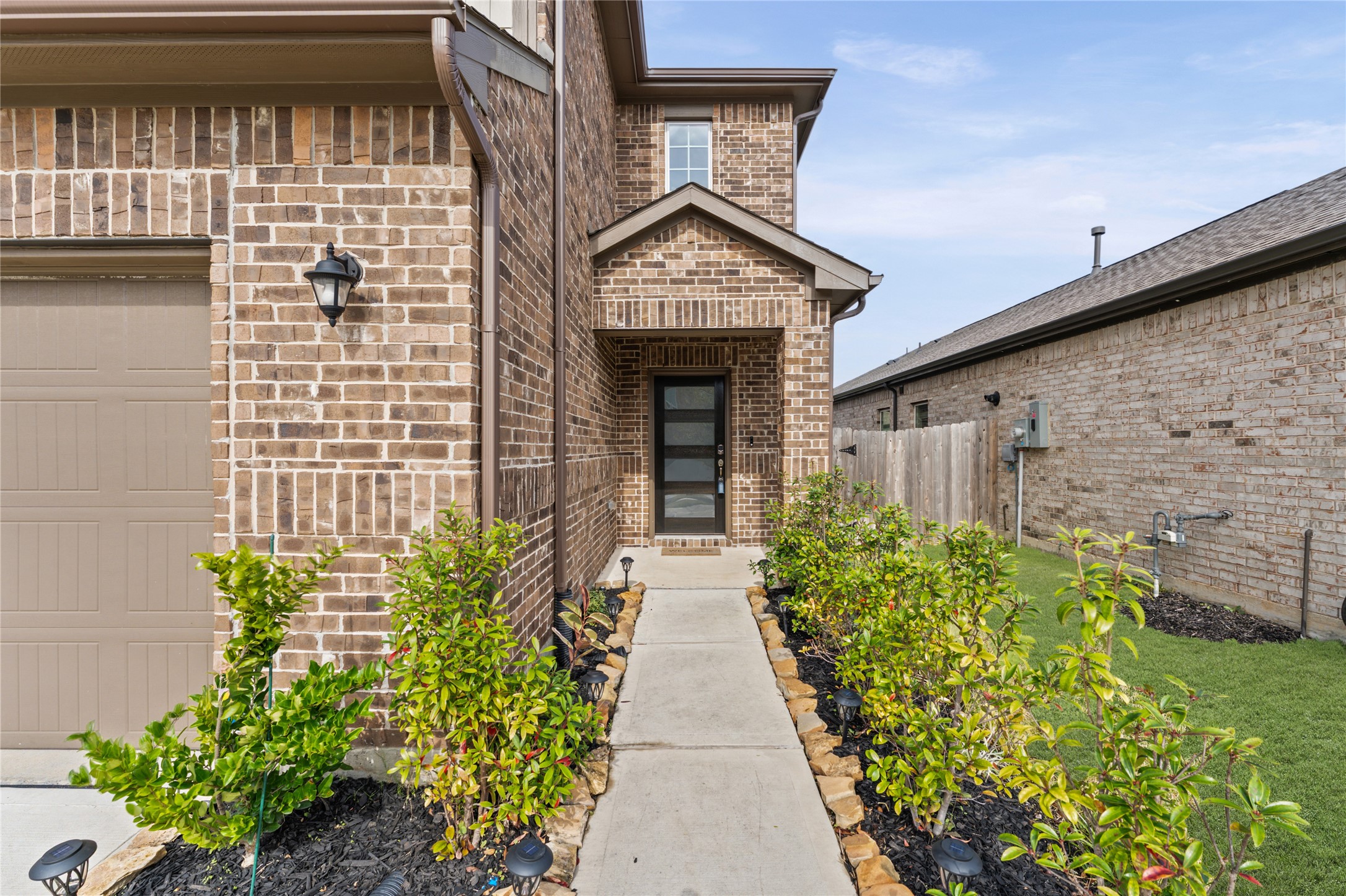 23326 Spring Genesis Lane Katy, TX 77493 - Photo 2 of 32 a front view of a house with garden
