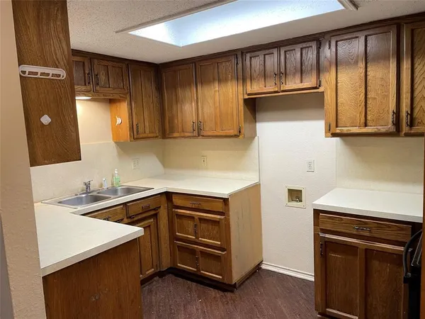 a kitchen with a sink and a refrigerator