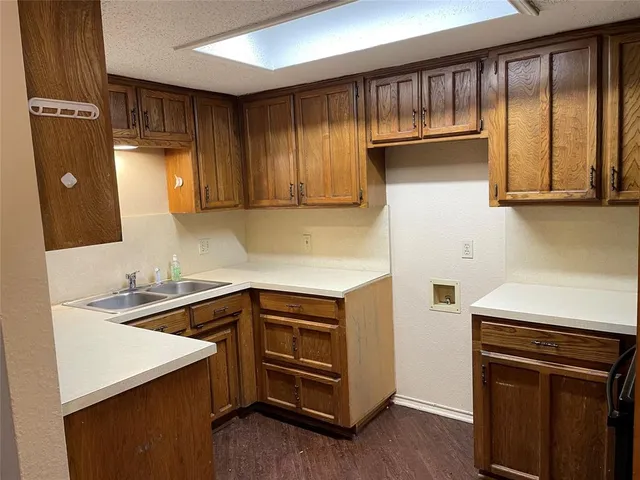 a kitchen with a sink and a refrigerator