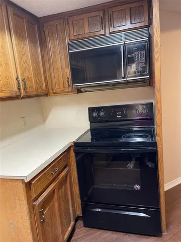 a stove top oven sitting inside of a kitchen