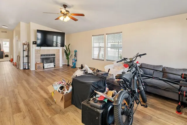 a view of a livingroom with furniture a flat screen tv and a fireplace