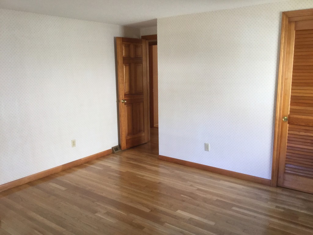 241 Megan Road Barnstable, MA 02601 - Photo 5 of 23 an empty room with wooden floor and windows