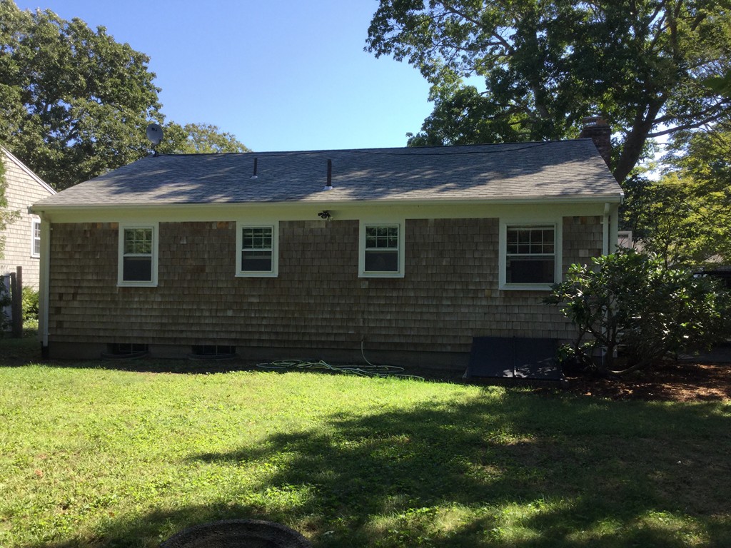 241 Megan Road Barnstable, MA 02601 - Photo 7 of 23 a brick house with a yard