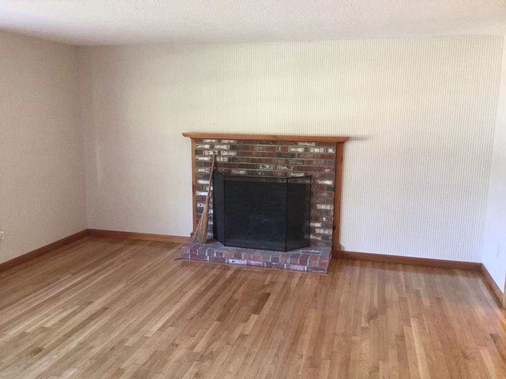 241 Megan Road Barnstable, MA 02601 - Photo 9 of 23 a view of empty room with wooden floor and fireplace