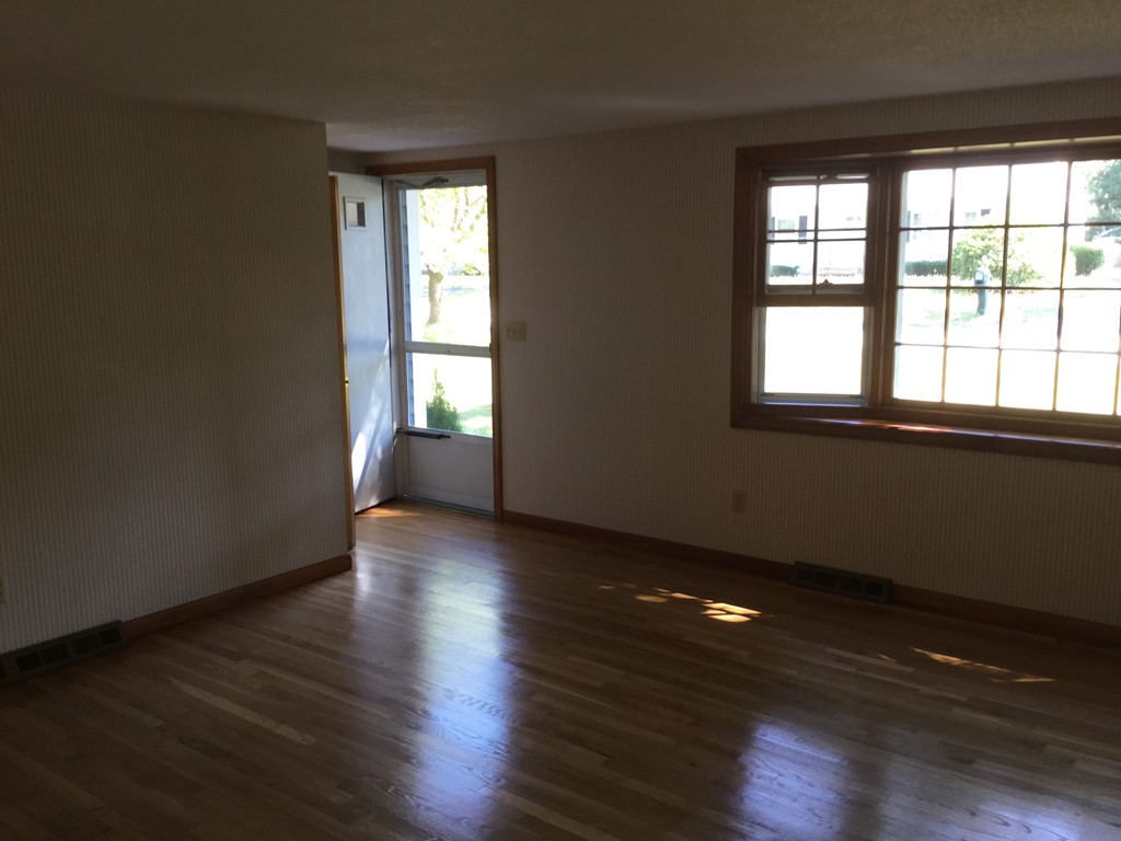 241 Megan Road Barnstable, MA 02601 - Photo 10 of 23 an empty room with wooden floor and windows