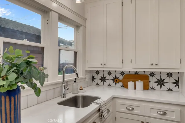 a kitchen with a sink a counter and cabinets