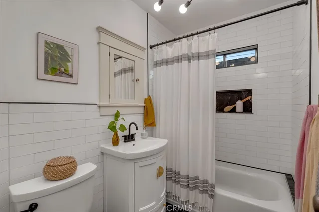 a bathroom with a sink a mirror and a shower