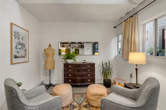 a living room with furniture a lamp and a large window