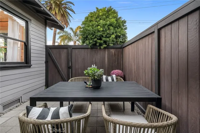 a backyard of a house with table and chairs