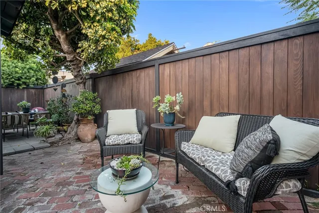 a outdoor living room with furniture and a potted plant