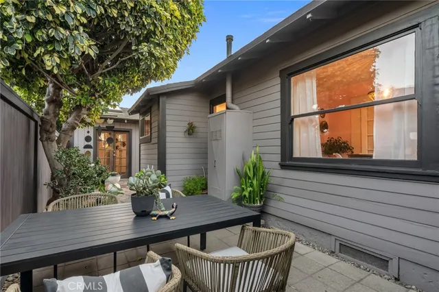 a view of a patio with couple of chairs and a fountain