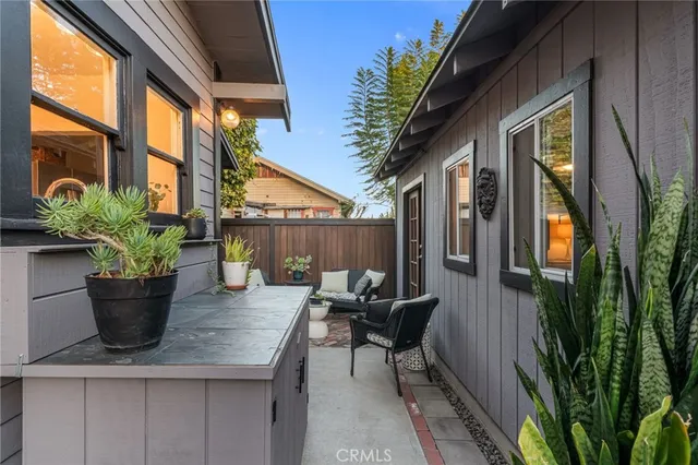a view of a patio with couple of chairs and a fountain