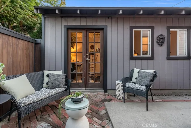 a outdoor living room with furniture and a potted plant