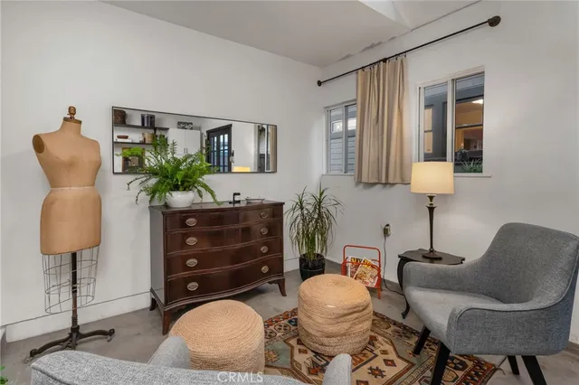 a living room with furniture a lamp and a large window