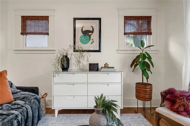 a bedroom with a bed and a potted plant
