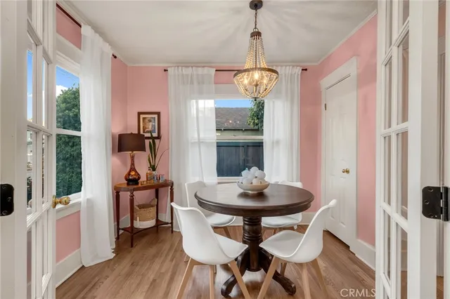 a view of a dining room with furniture wooden floor and chandelier