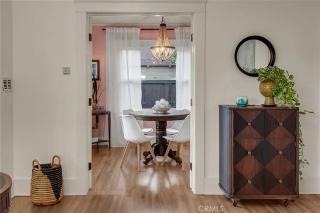 a view of a workspace with furniture and wooden floor