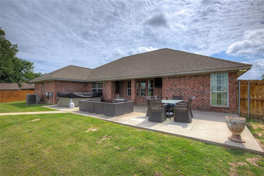 2027 Park Springs Road Sulphur Springs, TX 75482 - Photo 32 of 39 a patio with wooden table and chairs