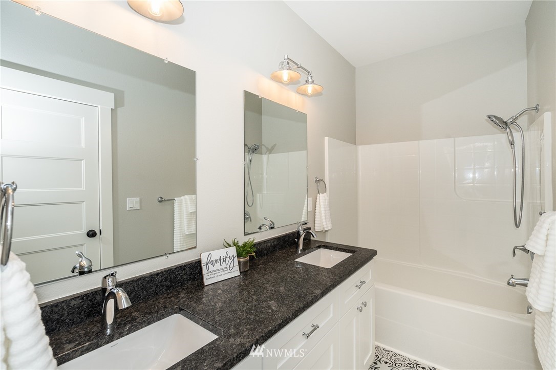 8414 James Road Southwest Rochester, WA 98579 - Photo 14 of 40 a bathroom with a granite countertop sink mirror and a bathtub