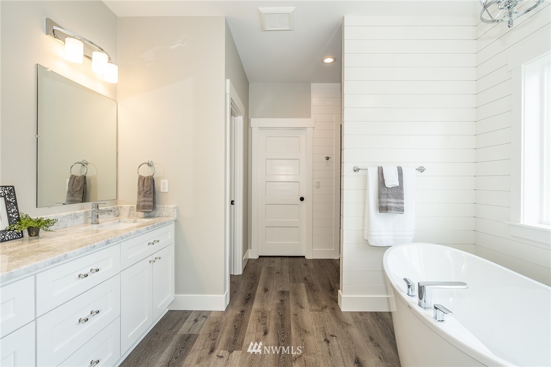 8414 James Road Southwest Rochester, WA 98579 - Photo 22 of 40 a bathroom with a sink a mirror and a bathtub