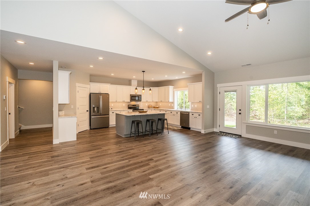 8414 James Road Southwest Rochester, WA 98579 - Photo 8 of 40 a view of kitchen with stainless steel appliances kitchen island wooden floors and white cabinets