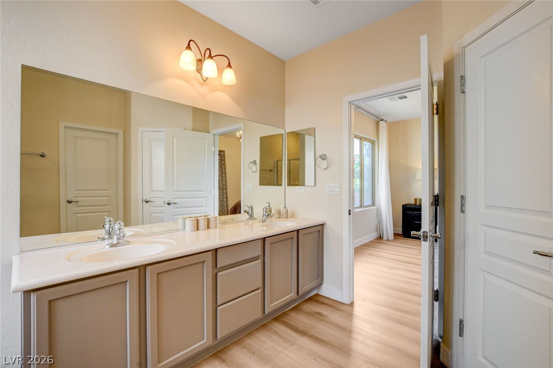 2649 Rue Marquette Avenue Henderson, NV 89044 - Photo 47 of 55 This primary bathroom features a vanity with dual sinks, offering functional elegance.