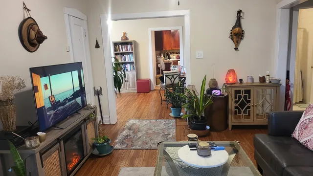 a living room with furniture and wooden floor