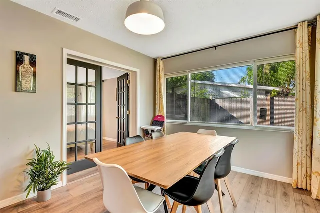 a view of a dining room with furniture window and wooden floor