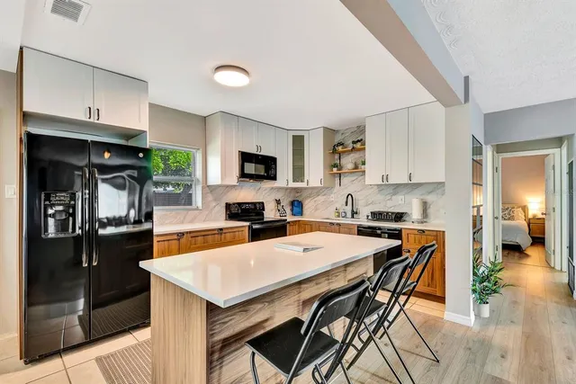 a kitchen with a stove a refrigerator and a sink