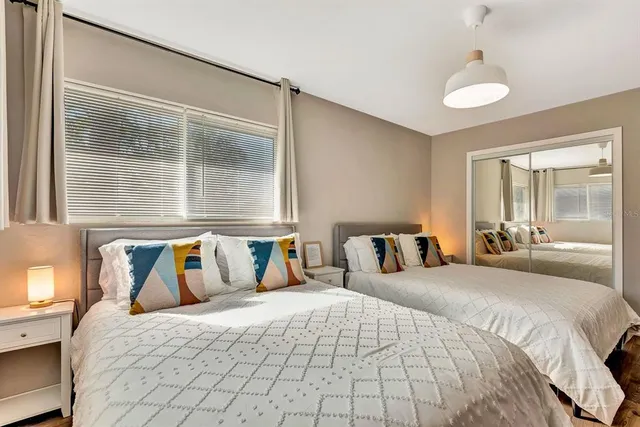 a bedroom with a large bed and a window