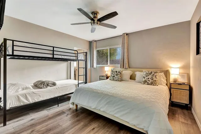 a bedroom with a bed and a ceiling fan