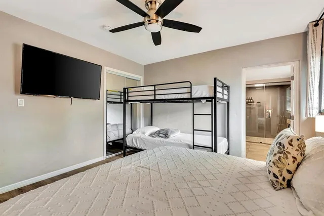 a room with a bed and a flat screen tv